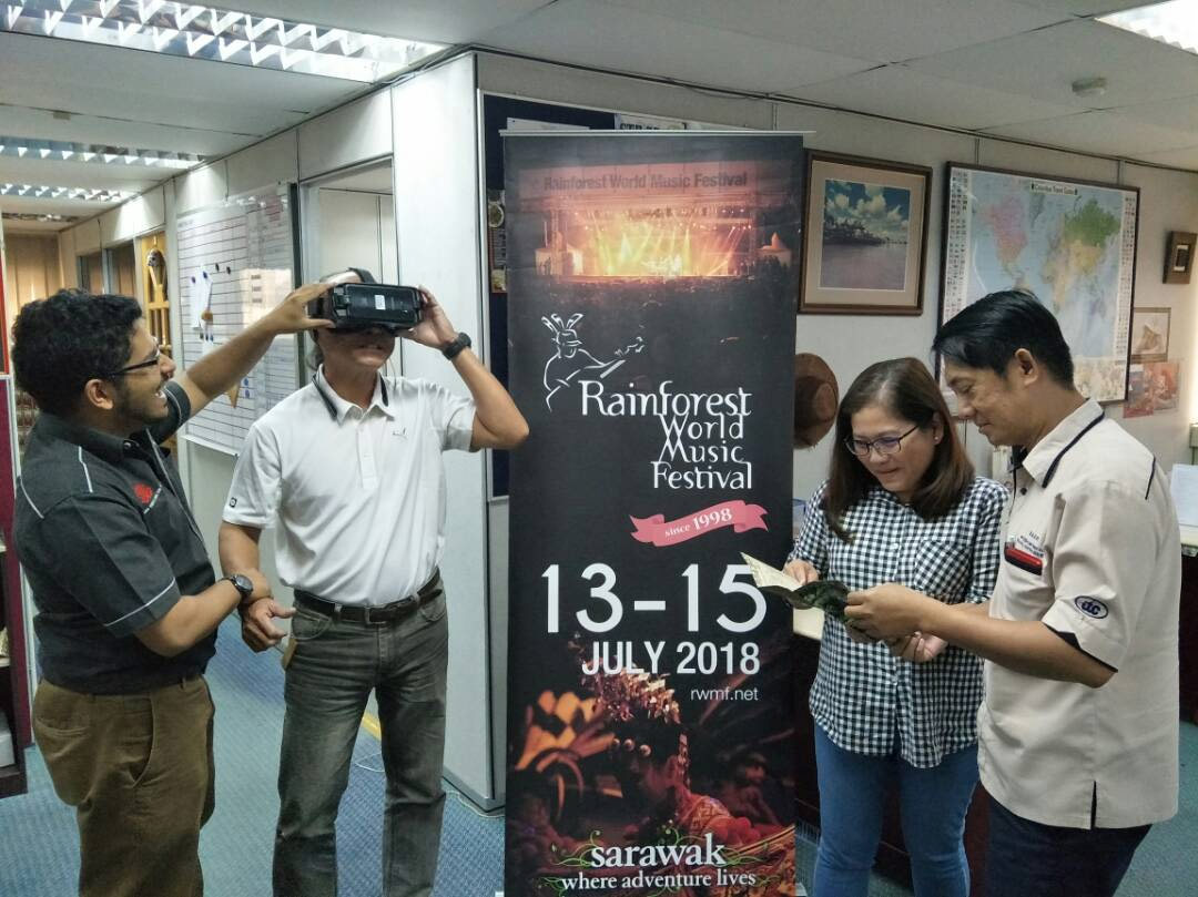 Image of exhibitors sampling the VR tour during a briefing at the Sarawak Tourism Board office.