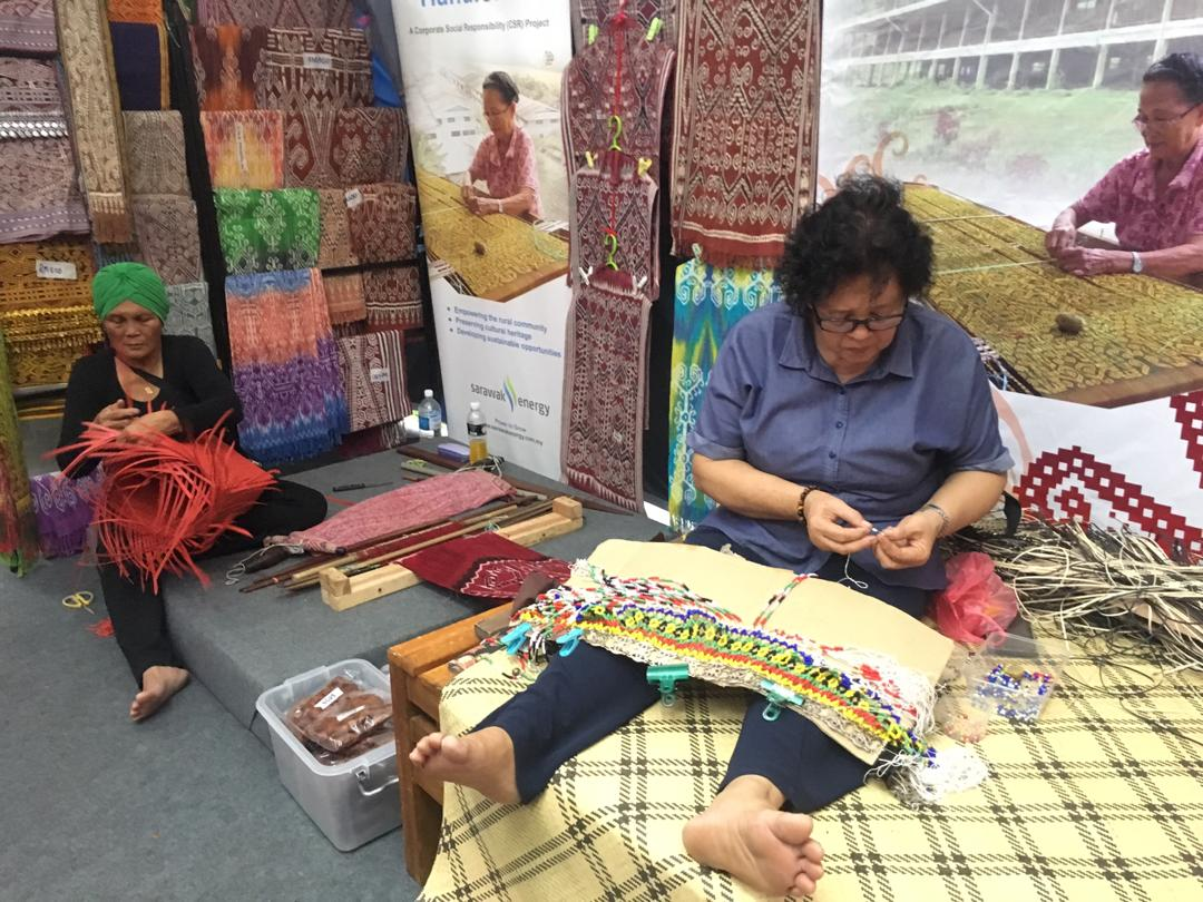 Craftswomen weaving textiles and baskets, and beading accessories. 