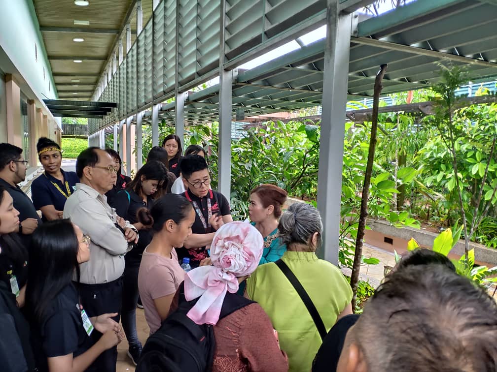 Photo shows Mdm. Jovita (in turquoise dress) explaining the function of each plant during the Ethnobotanical Garden walk 